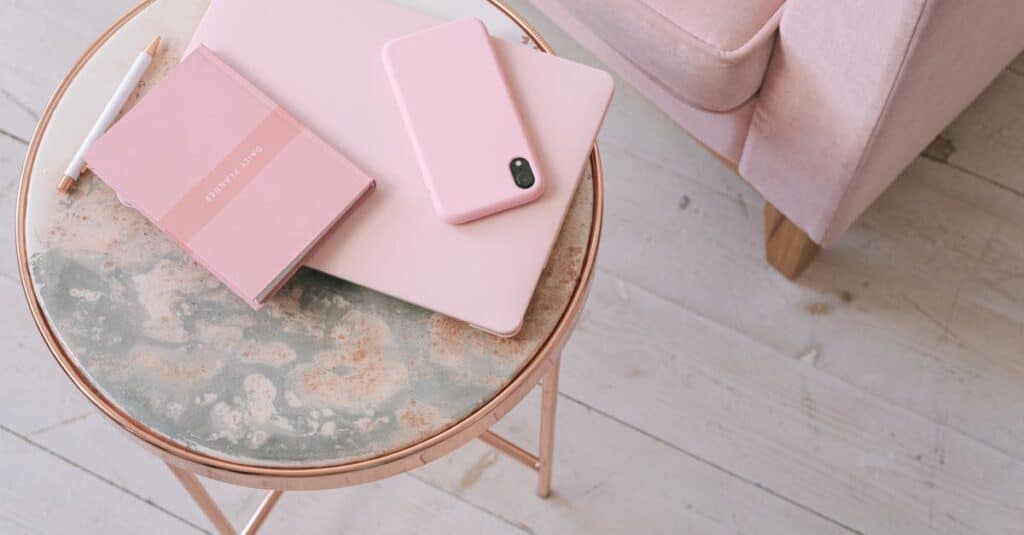 laptop and iphone with pink cases- Thom Tax